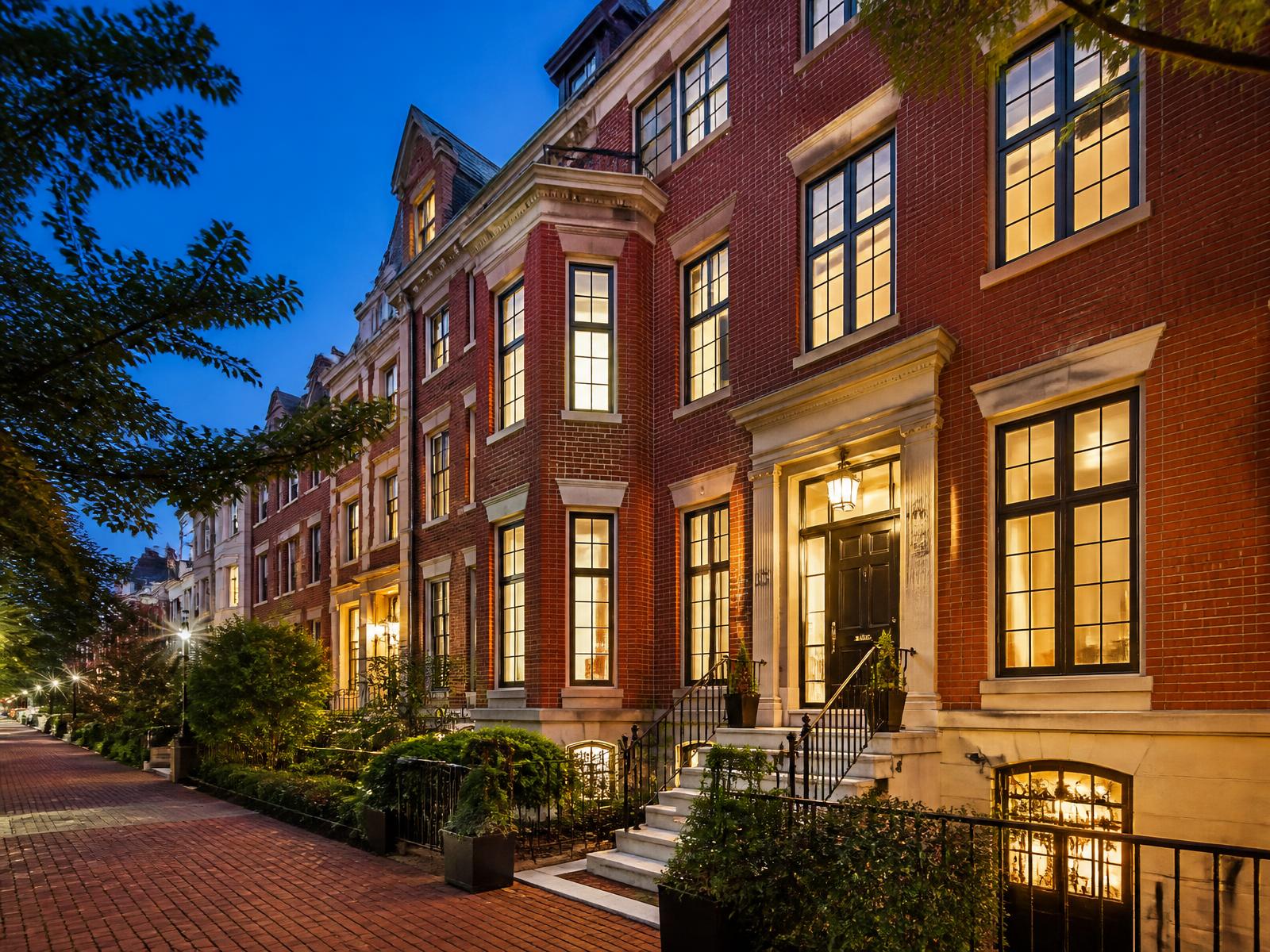 Washington DC brick townhome exterior at twilight with warm interior lights