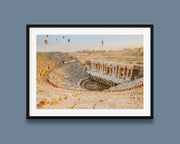 Black framed wall art featuring Hierapolis Ancient Theatre at sunrise, with stone amphitheater seats, Roman ruins, and hot air balloons in a pale morning sky.