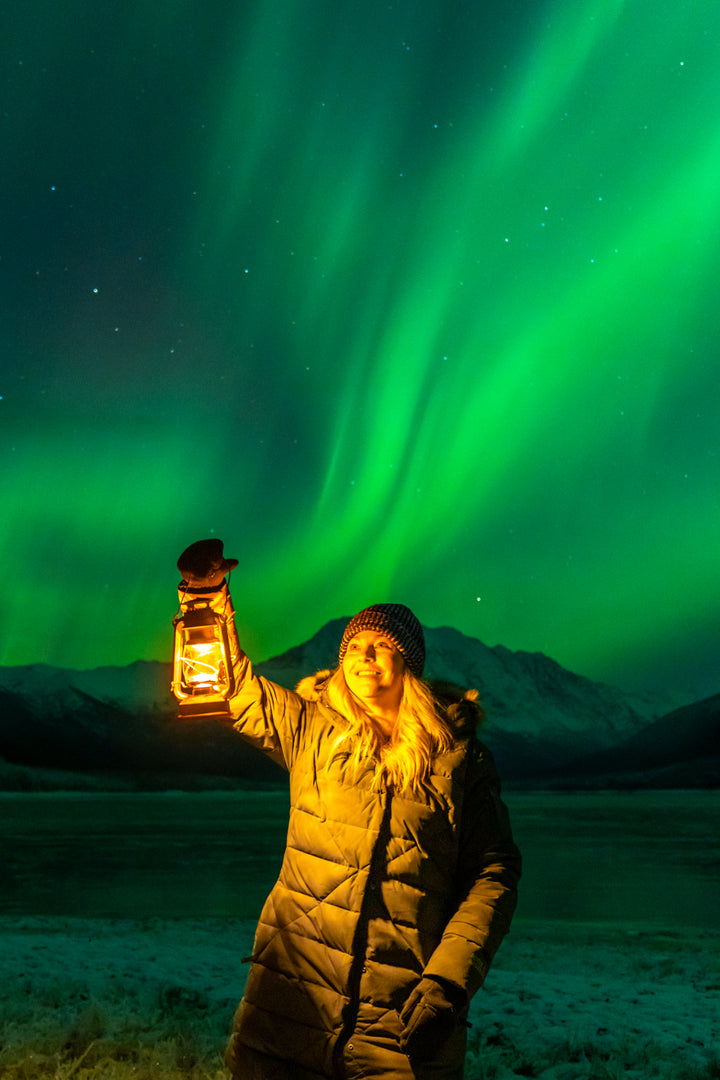 A solitary figure beneath the northern lights at Eklutna Lake, Alaska — the first night begins