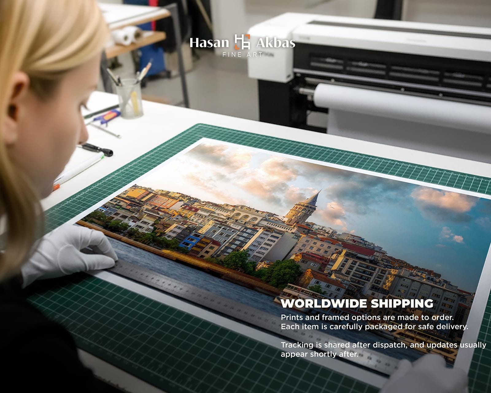Close-up of a large fine art print being measured by hand in a professional print studio. The image shows careful quality control, made-to-order production, and worldwide shipping preparation for framed and unframed art prints.